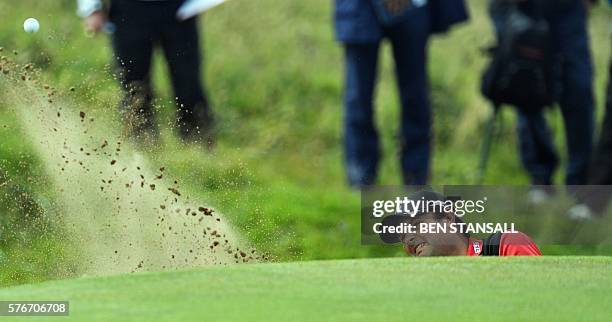 Golfer Patrick Reed plays from a green-side bunker on the on the 4th hole during his final round on day four of the 2016 British Open Golf...