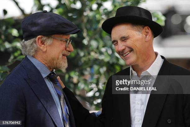 Director Steven Spielberg and British actor Mark Rylance react as they arrive to attend the UK premiere of the film "The BFG" in Leicester Square,...
