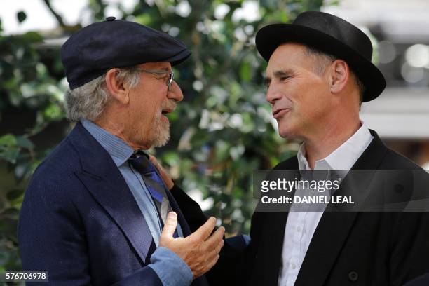 Director Steven Spielberg and British actor Mark Rylance react as they arrive to attend the UK premiere of the film "The BFG" in Leicester Square,...