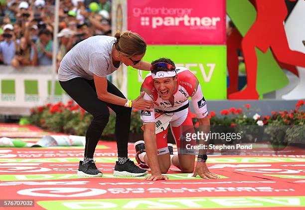 Jan Frodeno of Germany is greeted by his wife Emma Snowsill as he wins with a new world record time for long distance triathlon during the Challenge...