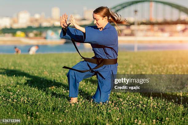 girl practicing aikido outdoors. - aikido stock pictures, royalty-free photos & images