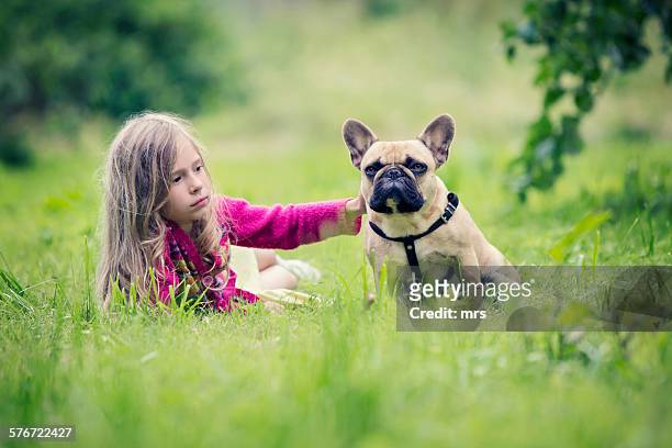 girl playing with dog (french bulldog) - latvia girls stock pictures, royalty-free photos & images