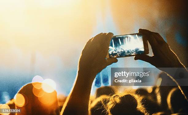 taping a concert with smartphone. - concert hands stock pictures, royalty-free photos & images