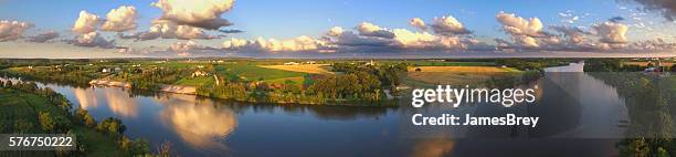 stunning panoramic landscape with clouds reflected in tranquil river - midwestern stock pictures, royalty-free photos & images