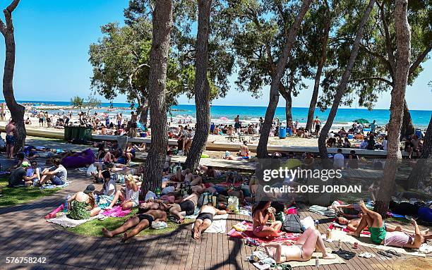 Revellers sleep on the grass near a beach on the fourth and last day of the 2016 Benicassim International Festival in Benicassim, in Castellon...