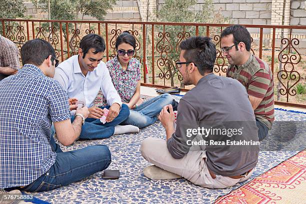 family relax in a garden at persian new year - persian new year nowruz stock pictures, royalty-free photos & images