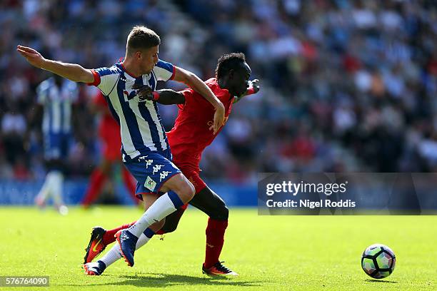 Ryan Colclough of Wigan Athletic challenges Sadio Mane of Liverpool during the Pre-Season Friendly match between Wigan Athletic and Liverpool at JJB...