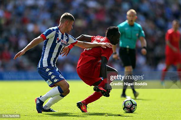 Ryan Colclough of Wigan Athletic challenges Sadio Mane of Liverpool during the Pre-Season Friendly match between Wigan Athletic and Liverpool at JJB...