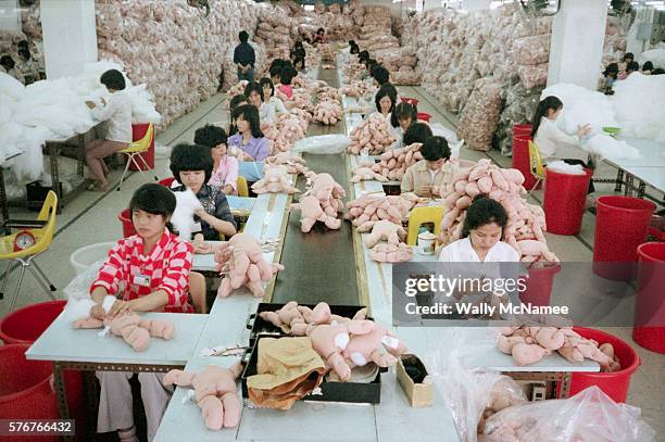 workers making cabbage patch dolls - sweatshop stock pictures, royalty-free photos & images