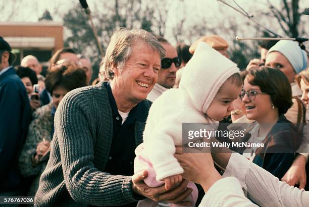 President Jimmy Carter greets friends and neighbors from Plains, Georgia on a visit home for the weekend, one month after his inauguration.