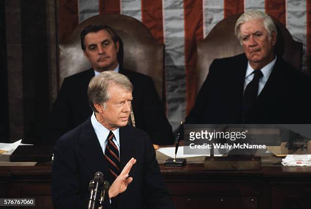 Vice President Walter Mondale, presiding over the Senate, and House Speaker Tip O'Neill listen as President Jimmy Carter speaks to a joint session of...