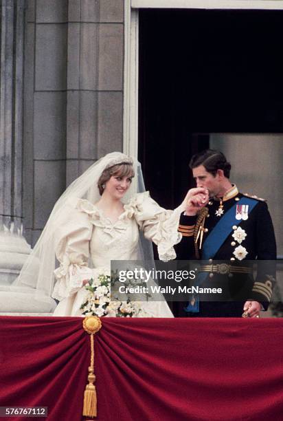 Prince Charles kisses the hand of his new bride, Princess Diana, on the balcony at Buckingham Palace just after their wedding.