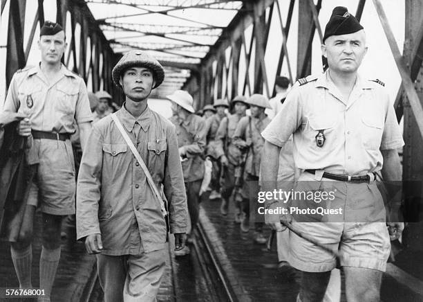 View of the victor and vanquished after the fall of the French base at Dien Bien Phu, Vietnam, 1954. The French commander turned over his garrison to...