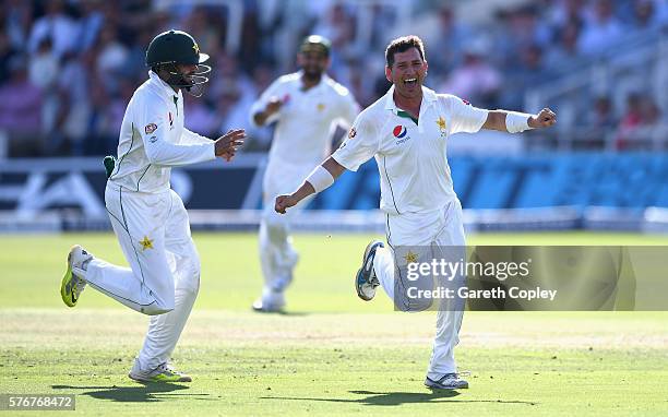 Yasir Shah of Pakistan celebrates with Azhar Ali after dismissing Chris Woakes of England during day four of the 1st Investec Test between England...