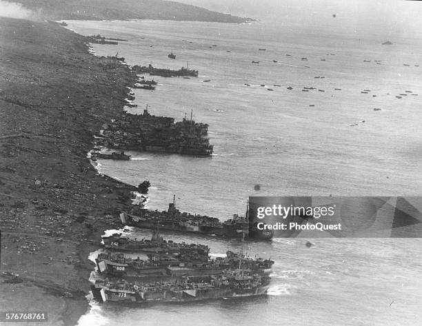 Photo taken from the top of Mt Suribachi show US ships unloading Marines on the beach, Iwo Jima, February 23, 1945.