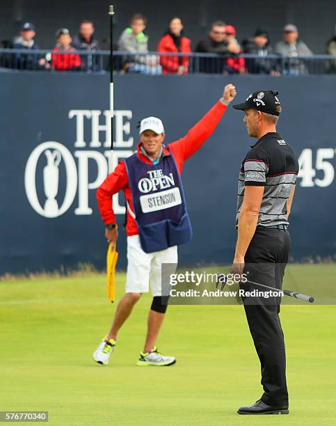 Henrik Stenson of Sweden celebrates victory with caddie Garath Lord after the winning putt during the final round on day four of the 145th Open...