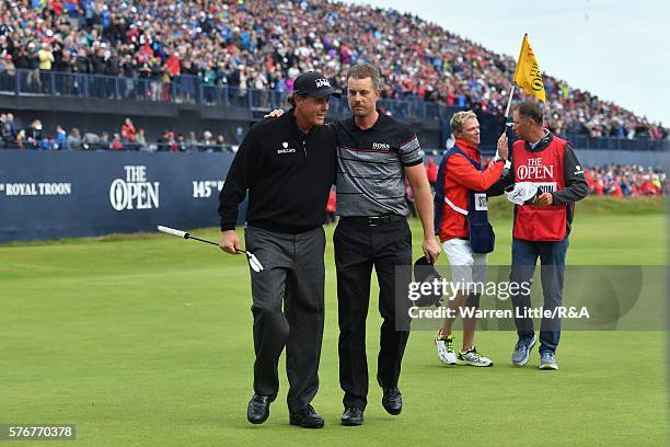 Henrik Stenson of Sweden is congratulated on his victory by Phil Mickelson of the United States on the 18th green during the final round on day four...