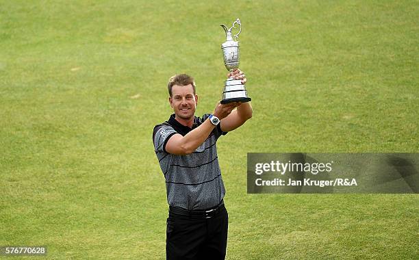 Henrik Stenson of Sweden lifts the Claret Jug on the 18th green following his victory during the final round on day four of the 145th Open...