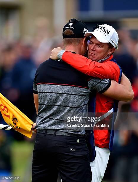 Henrik Stenson of Sweden celebrates victory with caddie Garath Lord after the winning putt during the final round on day four of the 145th Open...