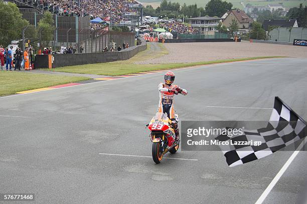 Marc Marquez of Spain and Repsol Honda Team cuts the finish lane and celebrates the victory at the end of the MotoGP race during the MotoGp of...