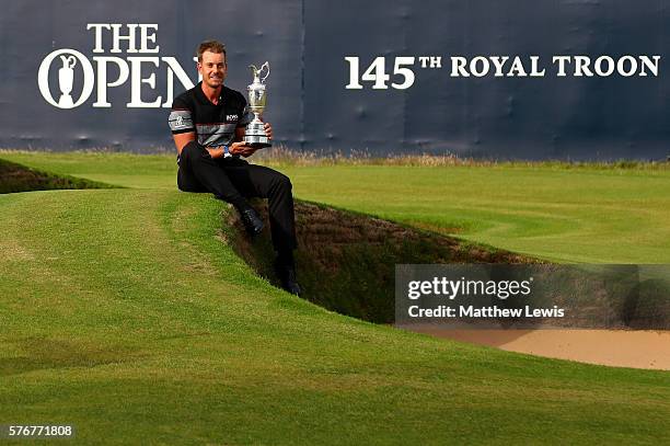 Henrik Stenson of Sweden celebrates victory as he poses with the Claret Jug on the the 18th green after the final round on day four of the 145th Open...