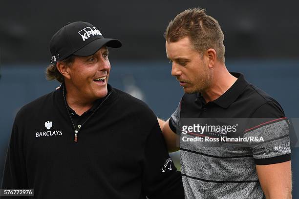 Henrik Stenson of Sweden is congratulated by Phil Mickelson of the United States on the 18th green during the final round on day four of the 145th...