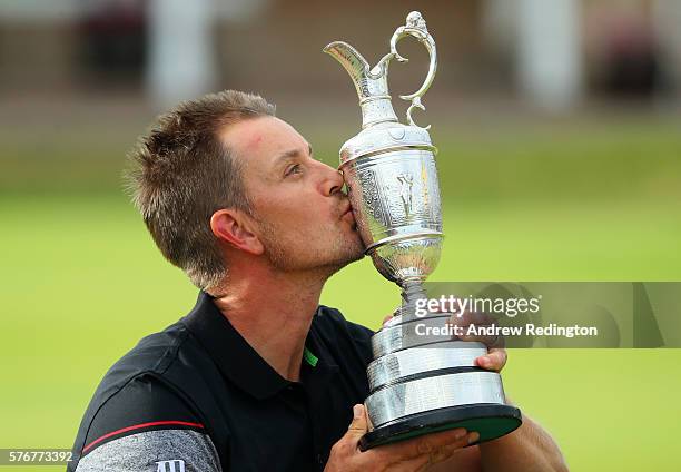 Henrik Stenson of Sweden celebrates victory as he poses with the Claret Jug on the the 18th green after the final round on day four of the 145th Open...