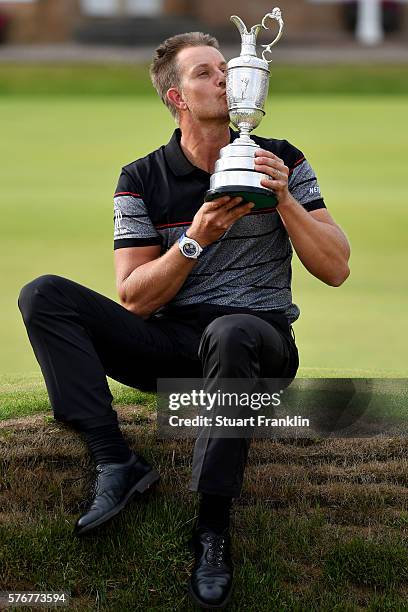 Henrik Stenson of Sweden celebrates victory as he poses with the Claret Jug on the the 18th green after the final round on day four of the 145th Open...