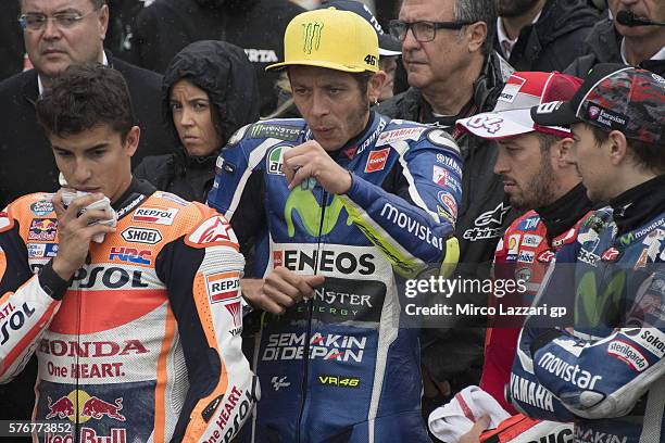 The paddock family pray in pit during the minute of silence in memory of those who lost their lives in Nice before the MotoGP race during the MotoGp...