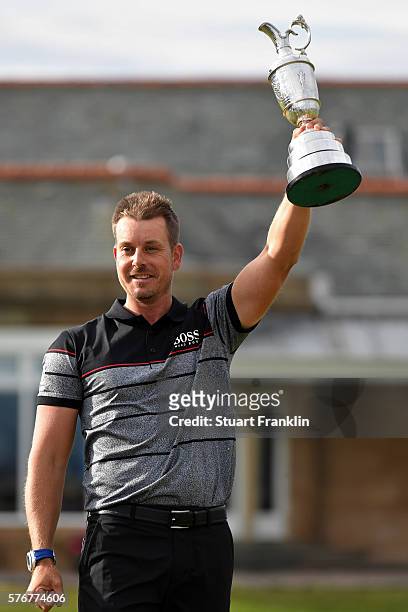 Henrik Stenson of Sweden celebrates victory as he poses with the Claret Jug on the the 18th green after the final round on day four of the 145th Open...