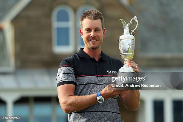 Henrik Stenson of Sweden celebrates victory as he poses with the Claret Jug on the the 18th green after the final round on day four of the 145th Open...