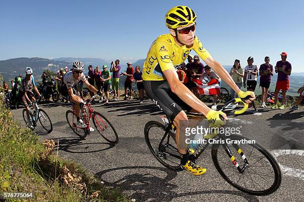 Christopher Froome of Great Britain riding for Team Sky in the yellow leader's jersey rides in the peloton up the Lacets du Grand Colombier during...