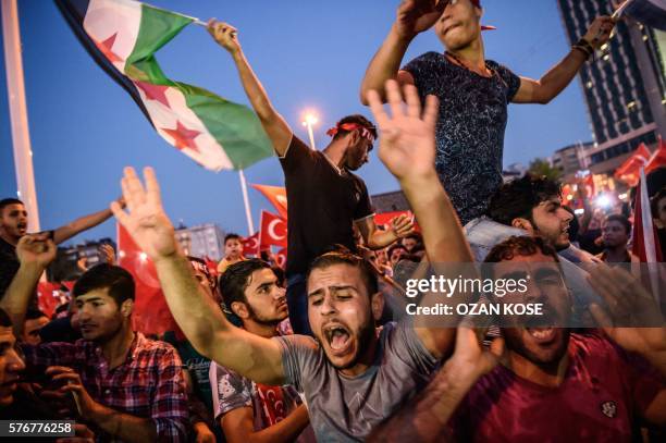 Graphic content / Demonstrators wave the flag of the Syrian opposition at Taksim square in Istanbul on July 17, 2016 during a demonstration in...