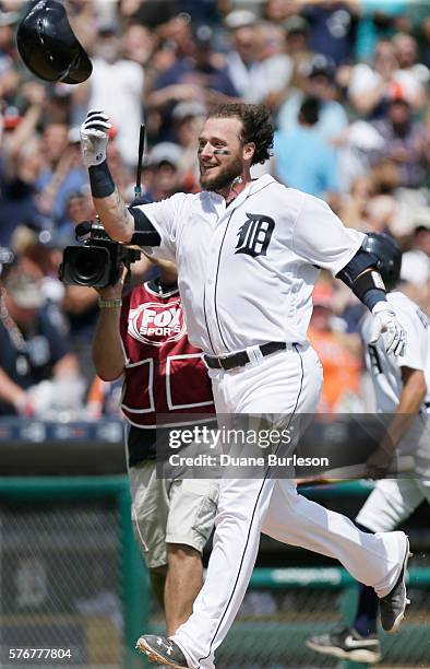Jarrod Saltalamacchia of the Detroit Tigers throws up his helmet while celebrating his walk-off home run in the ninth inning to defeat the Kansas...