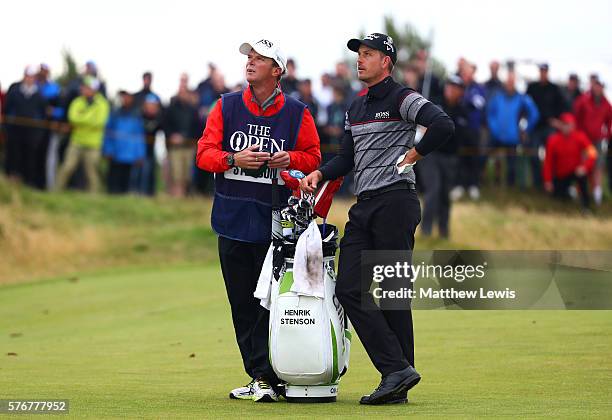 Henrik Stenson of Sweden and caddie Garath Lord look on from the on the 10th hole during the final round on day four of the 145th Open Championship...