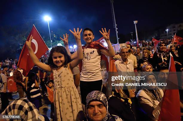 Children gesture on Taksim square in Istanbul on July 17 during a demonstration in support to the Turkish government following a failed coup attempt....