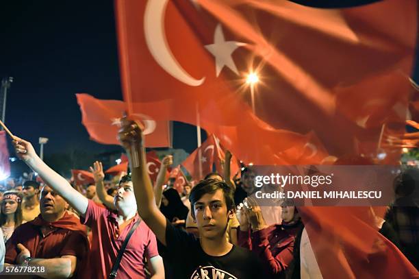 Boy waves a Turkish flag on Taksim square in Istanbul on July 17 during a demonstration in support to the Turkish government following a failed coup...