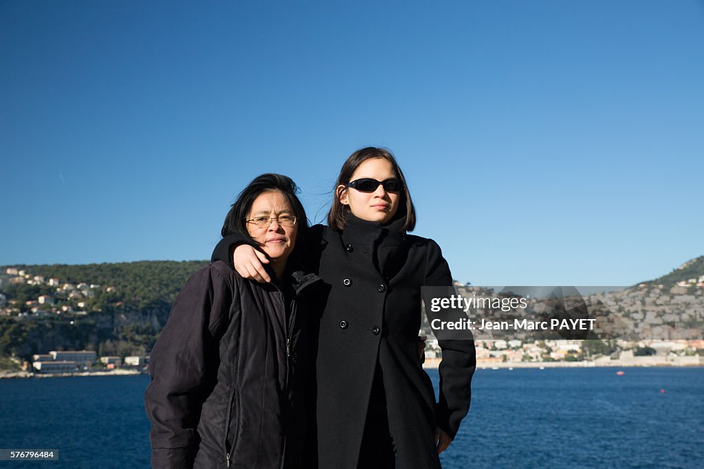 Asian mother and her daughter in front of the sea