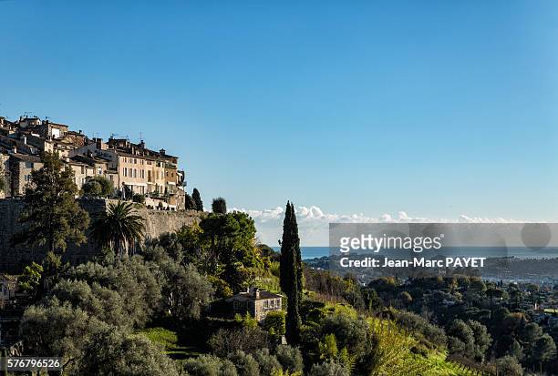village on a hill in front of the sea - jean marc payet stock pictures, royalty-free photos & images