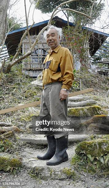 Japan - Yoshifumi Sato stands in front of his self-made shelter in Higashimatsushima, Miyagi Prefecture, on April 7, 2011. Sato's shelter built on a...