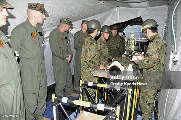 Fukushima, Japan - Handout photo shows members of the U.S. Marine Corps' Chemical Biological Incident Response Force being briefed about radiation...