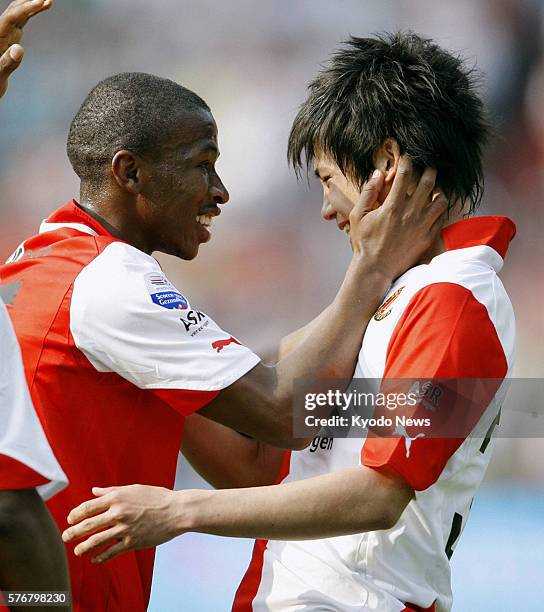 Netherlands - Feyenoord midfielder Ryo Miyaichi celebrates scoring a goal with his teammate during the first half of a Dutch first-division game...