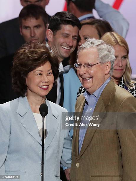 Senate Majority Leader Mitch McConnell , along with his wife Elaine Chao, and U.S. Speaker of the House Paul Ryan speaks during a microphone test...