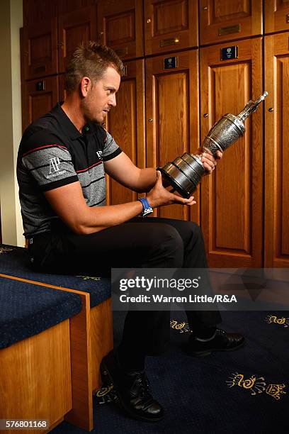 Henrik Stenson of Sweden looks at the Claret Jug in the Champions Locker Room following his victory during the final round on day four of the 145th...