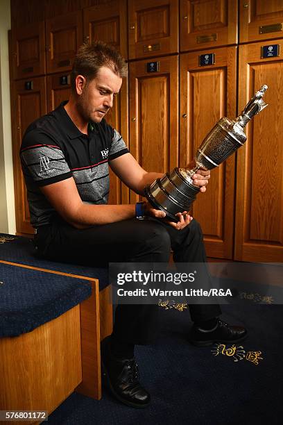 Henrik Stenson of Sweden looks at the Claret Jug in the Champions Locker Room following his victory during the final round on day four of the 145th...