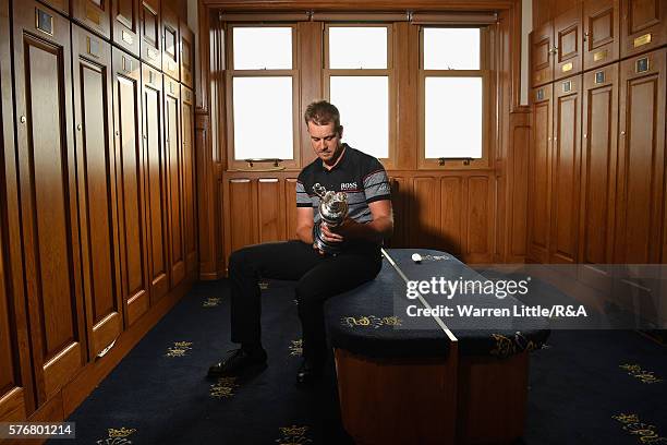 Henrik Stenson of Sweden looks at the Claret Jug in the Champions Locker Room following his victory during the final round on day four of the 145th...