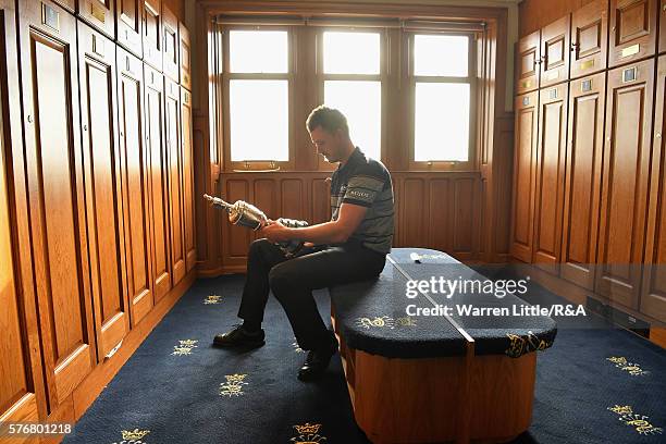 Henrik Stenson of Sweden looks at the Claret Jug in the Champions Locker Room following his victory during the final round on day four of the 145th...