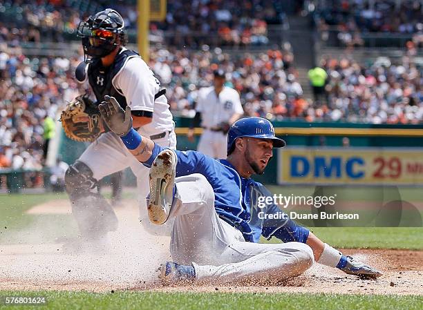 Paulo Orlando of the Kansas City Royals scores against catcher Jarrod Saltalamacchia of the Detroit Tigers on a double by Cheslor Cuthbert of the...