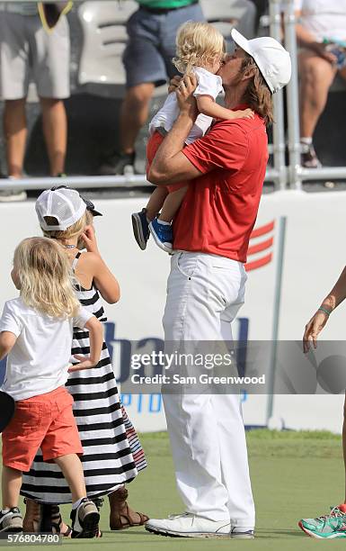 Aaron Baddeley of Australia celebrates with his family after his putt on the fourth hole of the playoff to win against Si Woo Kim of Korea during the...