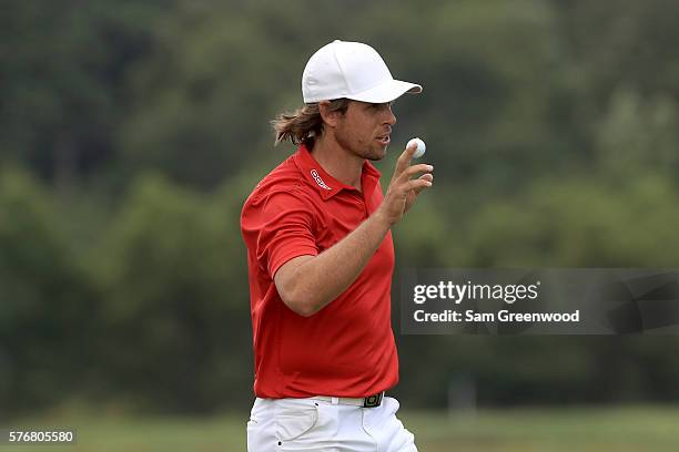 Aaron Baddeley of Australia acknowledges the crowd after his birdie on the third playoff hole against Si Woo Kim of Korea during the final round of...